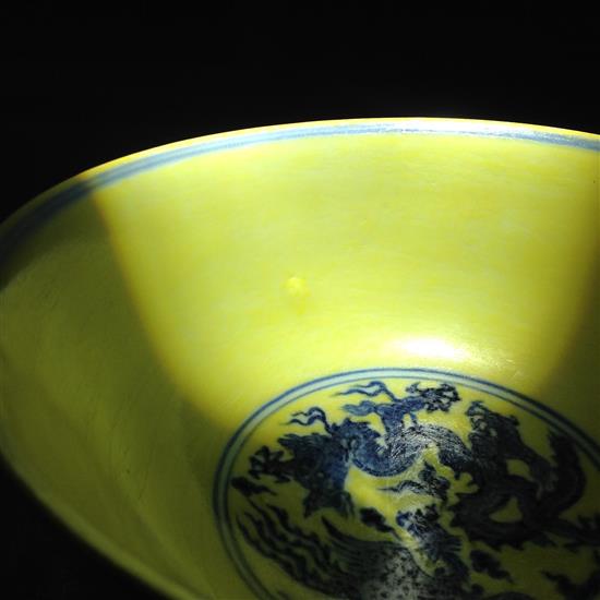 A Chinese yellow ground dragon and phoenix bowl, Xuande six character mark and possibly of the period, 19.5cm, museum restoration, sc